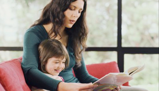 Mother helping her child read using kiddoread program